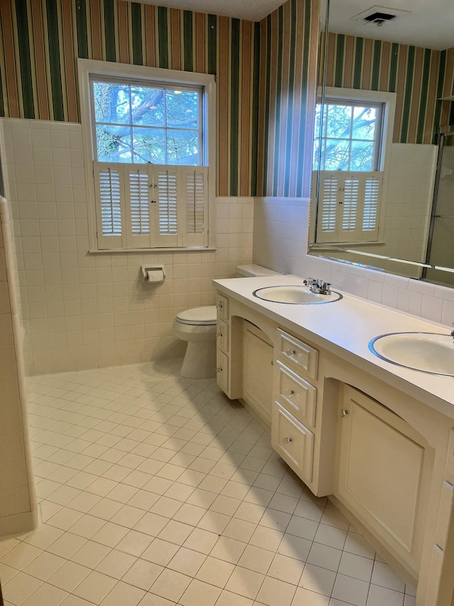 bathroom featuring toilet, vanity, and tile patterned flooring