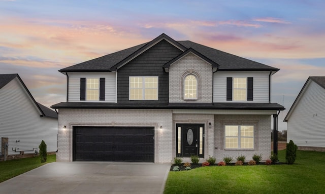 view of front facade featuring a garage and a yard