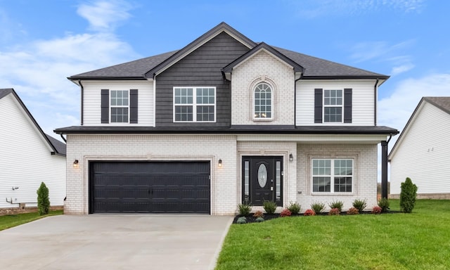 view of front of house with a garage and a front lawn