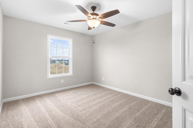 spare room featuring ceiling fan and carpet flooring