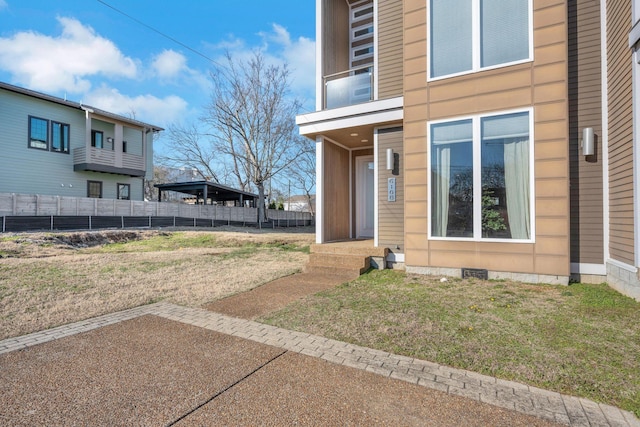 doorway to property with a yard