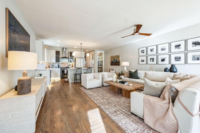 living room with ceiling fan and hardwood / wood-style floors