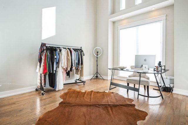 office featuring a high ceiling and hardwood / wood-style flooring