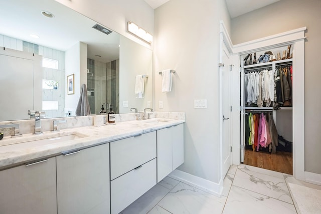 bathroom with vanity and tiled shower