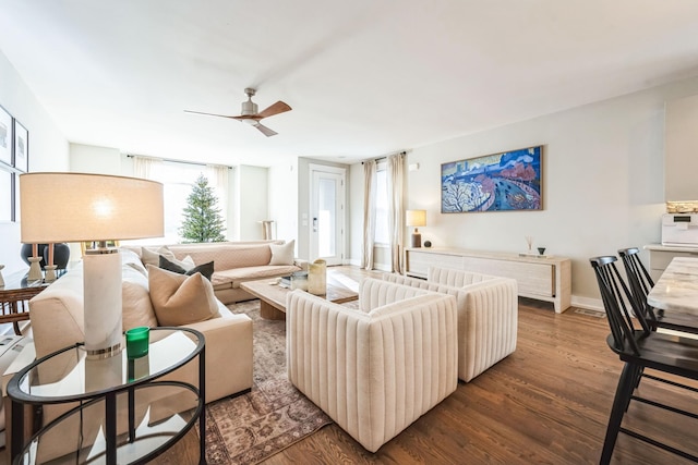 living room featuring ceiling fan, plenty of natural light, and dark hardwood / wood-style flooring