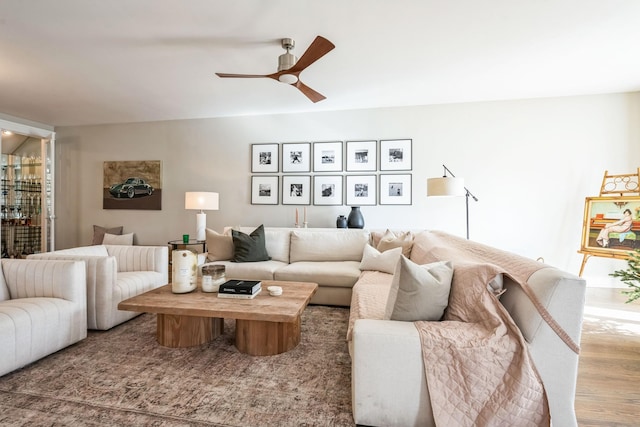 living room featuring ceiling fan and hardwood / wood-style flooring