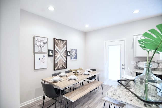 dining space with hardwood / wood-style floors