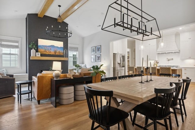 dining room with high vaulted ceiling, light hardwood / wood-style flooring, and beamed ceiling