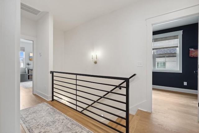 corridor with light hardwood / wood-style flooring