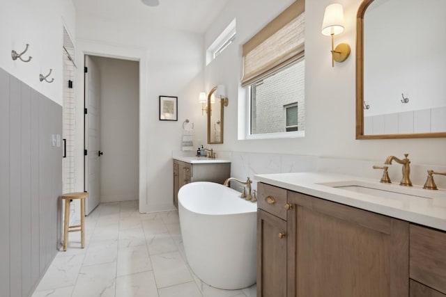 bathroom with a tub to relax in and vanity