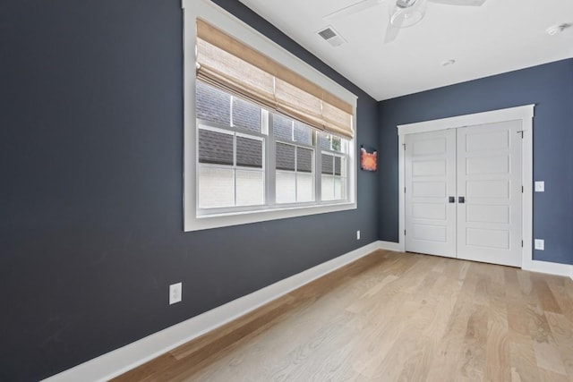 unfurnished bedroom featuring ceiling fan, a closet, and light hardwood / wood-style flooring