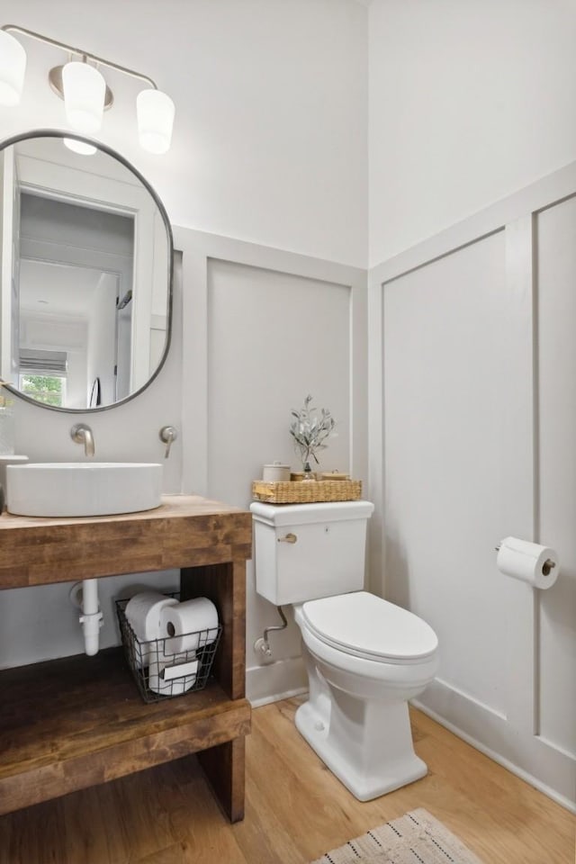 bathroom featuring sink, hardwood / wood-style floors, and toilet