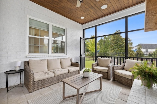 sunroom with wooden ceiling, plenty of natural light, and ceiling fan