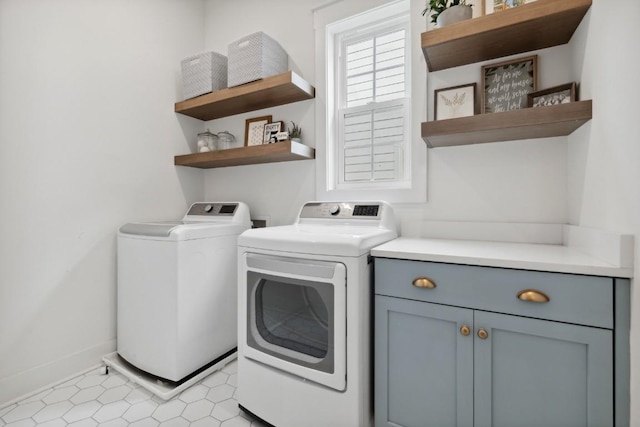 laundry area featuring washer and dryer and cabinets