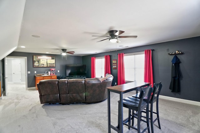 carpeted living room featuring ceiling fan