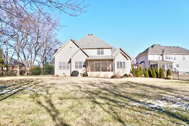 back of house featuring a sunroom and a yard