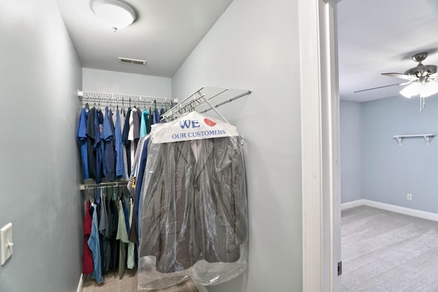 spacious closet with carpet floors and ceiling fan