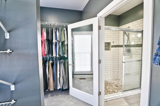 bathroom featuring an enclosed shower