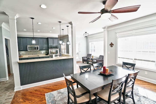 dining area with ceiling fan, ornamental molding, hardwood / wood-style floors, and decorative columns