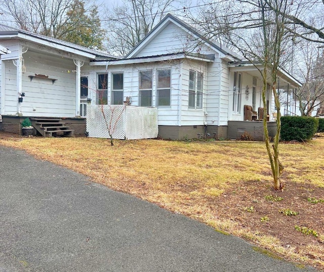 view of home's exterior featuring a yard and covered porch