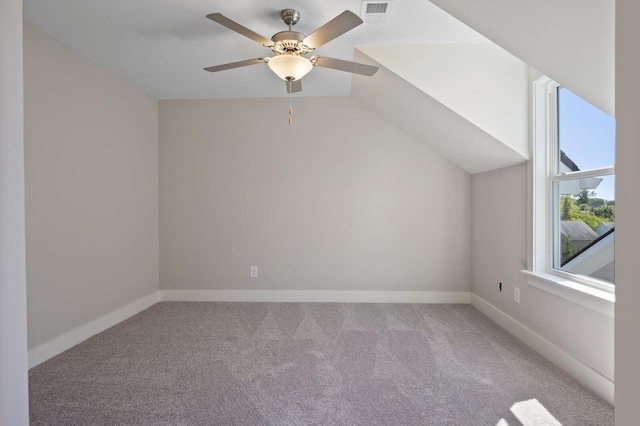 additional living space featuring ceiling fan, light carpet, and vaulted ceiling