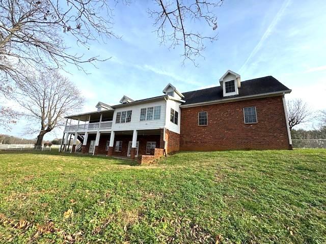 back of house with a yard