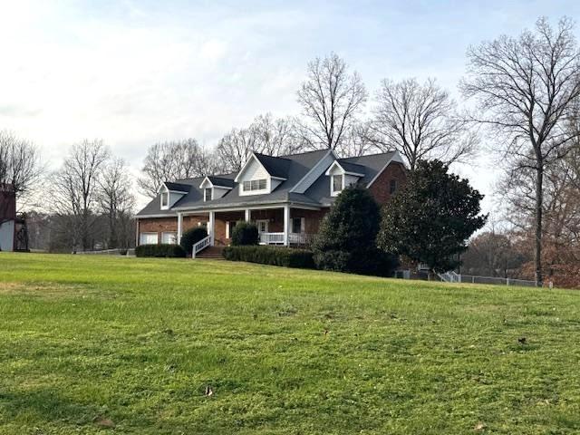 new england style home with a front lawn and a porch