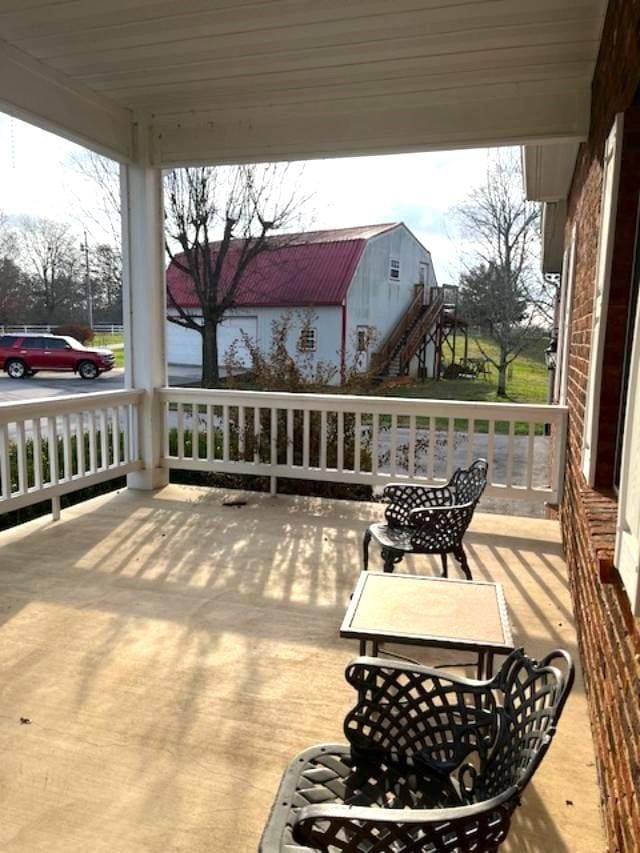 wooden terrace featuring covered porch