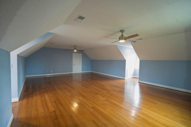 bonus room with vaulted ceiling, ceiling fan, and light wood-type flooring