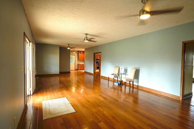 spare room featuring ceiling fan, wood-type flooring, and a textured ceiling