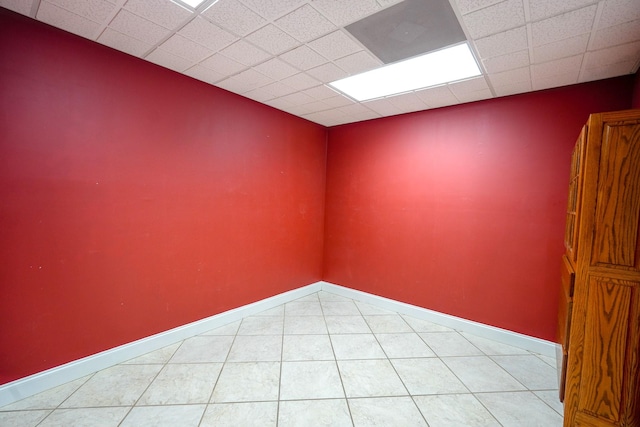 unfurnished room featuring a drop ceiling