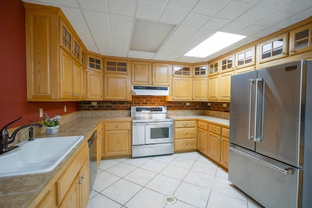 kitchen featuring light tile patterned floors, appliances with stainless steel finishes, and sink