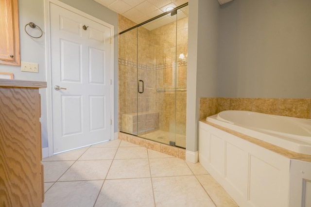 bathroom featuring shower with separate bathtub and tile patterned floors