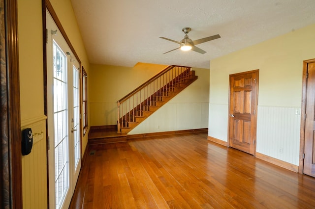 spare room featuring ceiling fan, wood-type flooring, and a textured ceiling