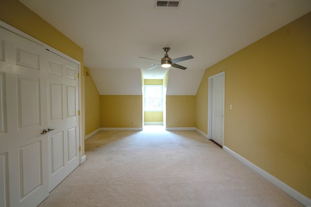 bonus room featuring light carpet, ceiling fan, and vaulted ceiling