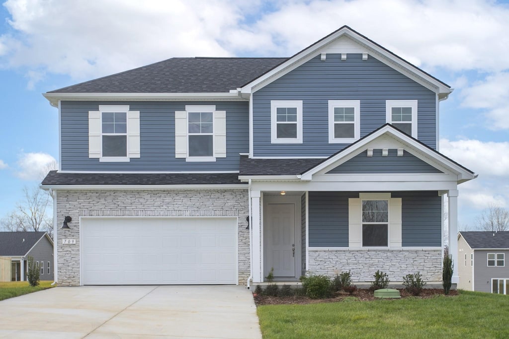 view of front facade with a front lawn and a garage