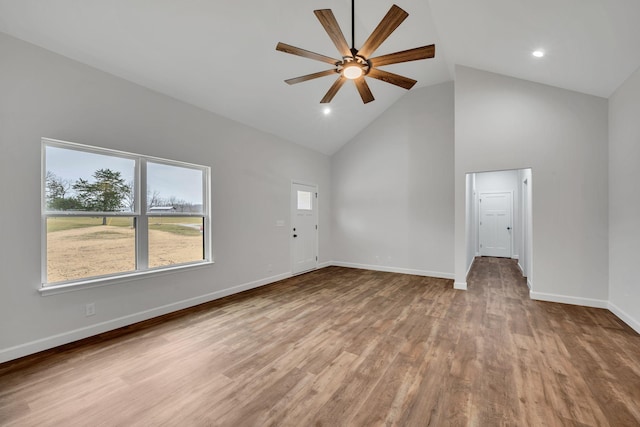 unfurnished living room featuring ceiling fan, high vaulted ceiling, and light hardwood / wood-style flooring