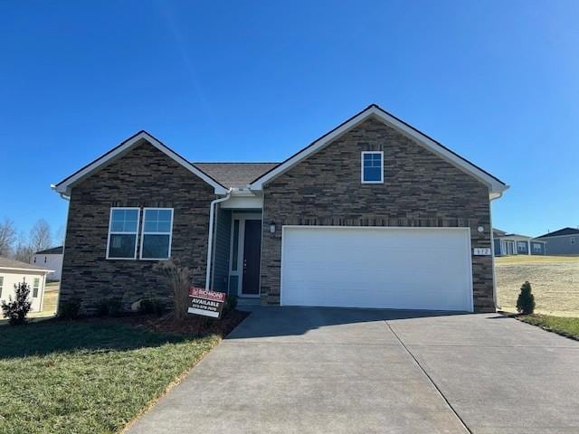 view of front of property with a garage and a front yard