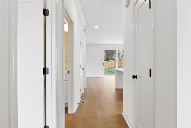 corridor with baseboards, visible vents, wood finished floors, and recessed lighting