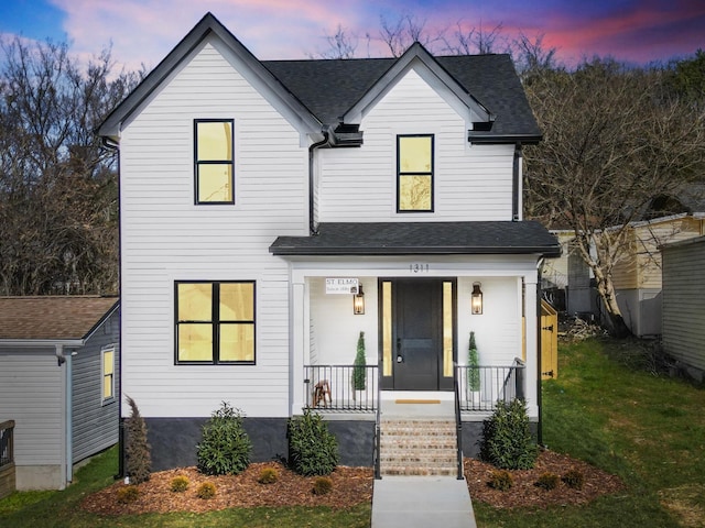 view of front of home featuring a porch and a shingled roof