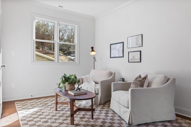 living area featuring hardwood / wood-style flooring and crown molding