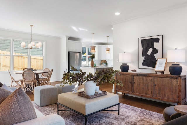 living room with a healthy amount of sunlight, ornamental molding, and dark hardwood / wood-style flooring