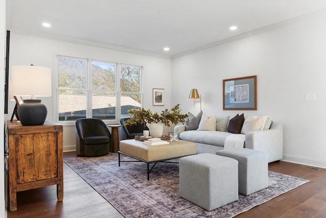 living area featuring ornamental molding, recessed lighting, baseboards, and wood finished floors