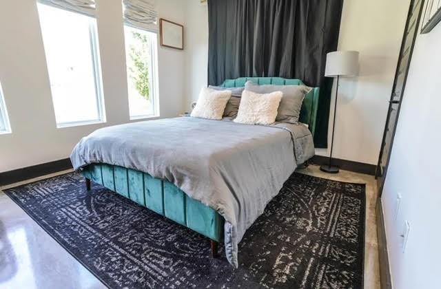 bedroom featuring concrete floors