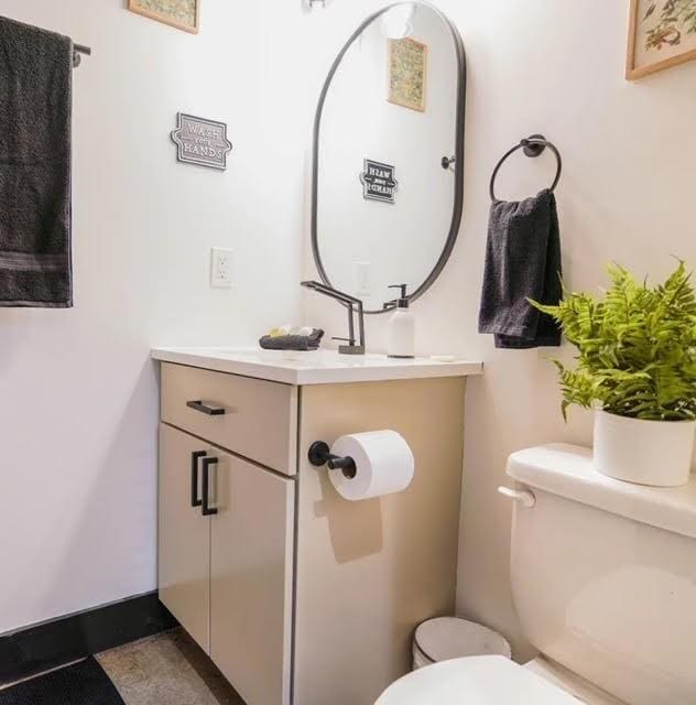 bathroom featuring toilet and vanity