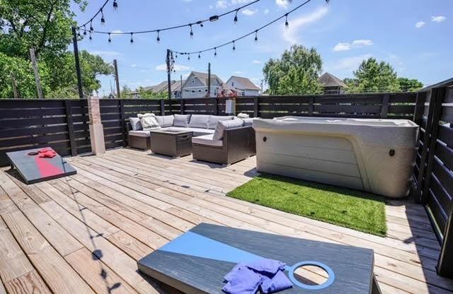 wooden deck with an outdoor living space with a fire pit