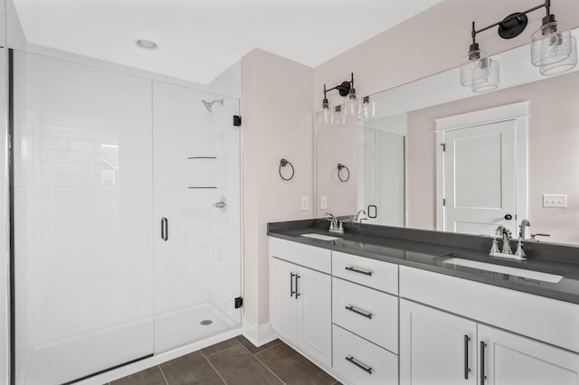 bathroom featuring an enclosed shower, vanity, and tile patterned flooring