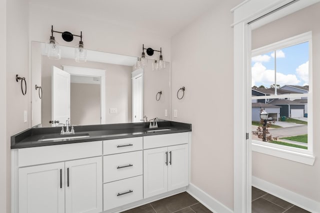 bathroom featuring plenty of natural light, vanity, and tile patterned flooring