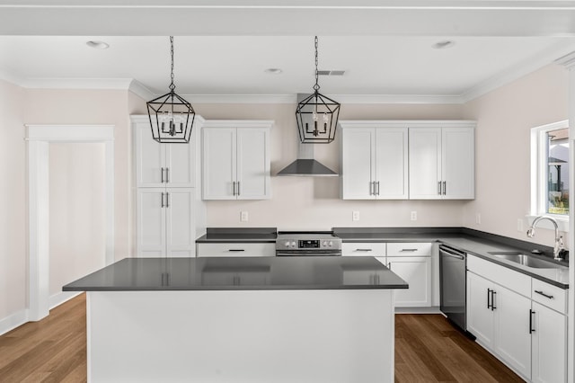 kitchen with pendant lighting, appliances with stainless steel finishes, a kitchen island, white cabinetry, and sink