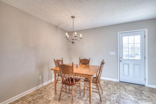 dining room featuring a chandelier and a textured ceiling